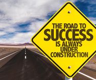 The Road to Success is Always Under Construction sign on desert road